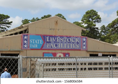 Old Livestock Auction Barn With Peeling Paint On Sign