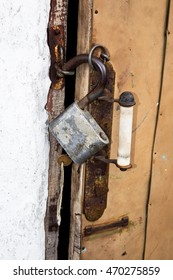 Old Lock With A Key On The Old Shabby Door