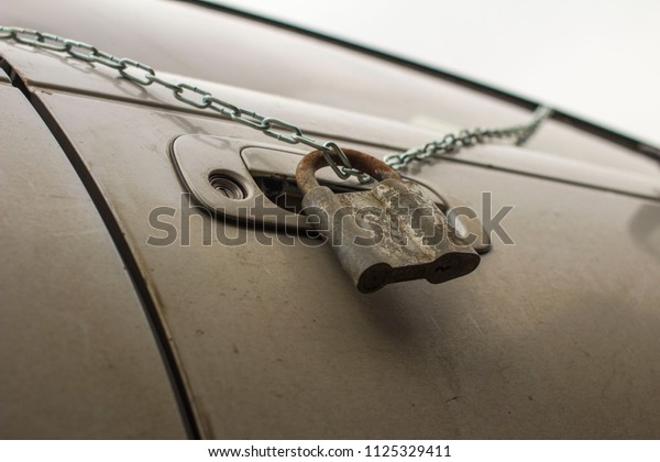 old lock on\
the chain on the driver\'s car\
door