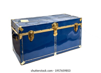 An old locked blue metal steamer trunk isolated on white