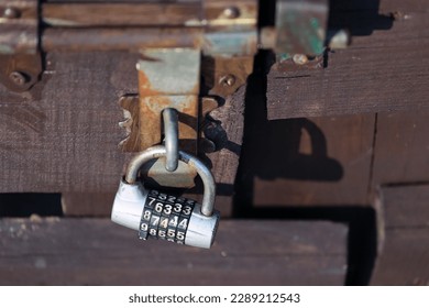 Old locked door secured with a padlock.