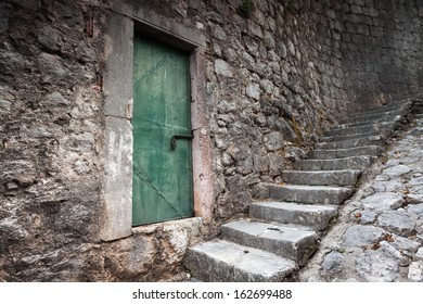 Old locked green door and stone stairway in Perast town, Montenegro - Powered by Shutterstock