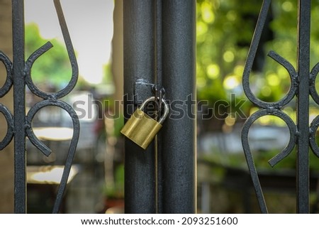 Old Locked Padlock Hanging On The Old Fashioned Metal Gate