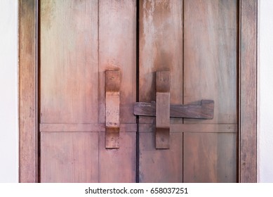 Old locking system, treditional ancient door. Wooden cabinet door and lock at handle.