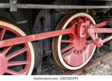 Old locomotive wheels on rails, train wheels on railway, railways closeup with rusty old locomotive wheels in an European train station