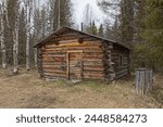 Old log cabin in cloudy spring weather at Riutukka Log Floating Museum, Salla, Lapland, Finland.