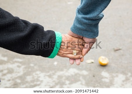 Old lovers holding hands as they walk