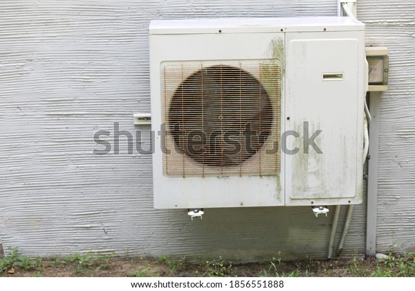 old machine of a rusty air conditioner to cool in\
the summer