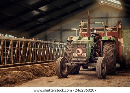Old, machine and tractor in barn on farm with dirt, rust and dust in storage warehouse on land. Vintage, retro and motor with plow truck in factory shed or tools for farming production or agriculture