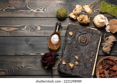 Old magic book and dry natural herbs and remedy bottle on the wooden table flat lay background with copy space. - Shutterstock ID 2221298989