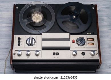 Old Magnetic Tape Recorder On A Gray Table Background