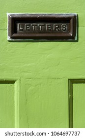 Old Mail Letter Box In A Distressed Green House Front Door