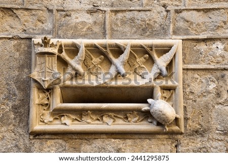 old mailbox facade made of marble with birds and a turtle in the gothic area of Barcelona, catalonia, spain