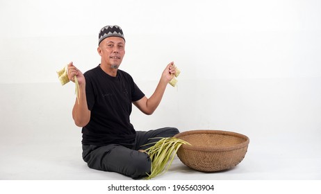 The Old Malay Man Weaving Ketupat Coconut Leaf. Ketupat Is The Traditional Food Of Malaysia During The Hari Raya Festival. It Is Made Of Palm Leaves And A Bit Of Rice Included In It.

