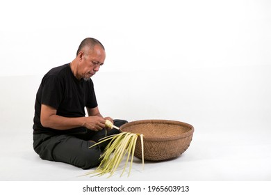 The Old Malay Man Weaving Ketupat Coconut Leaf. Ketupat Is The Traditional Food Of Malaysia During The Hari Raya Festival. It Is Made Of Palm Leaves And A Bit Of Rice Included In It.

