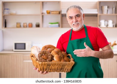 Old Male Baker Working In The Kitchen 