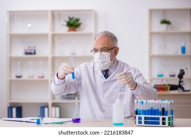 Old Male Chemist Working At The Lab