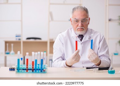 Old Male Chemist Working In The Lab