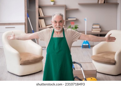 Old male contractor cleaning the house - Shutterstock ID 2310718493