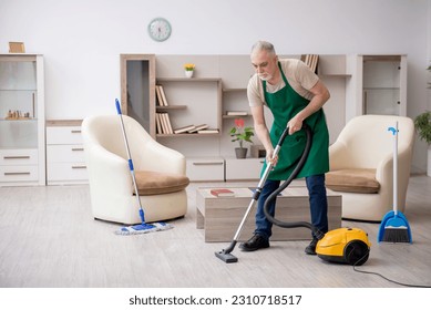 Old male contractor cleaning the house - Shutterstock ID 2310718517