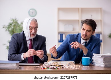 Old Male Employee Suffering From Toothache In The Office