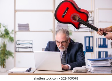 Old male employee unhappy with excessive work in the office