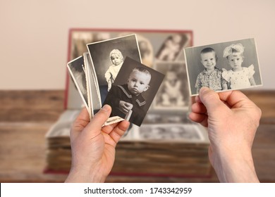 old man’s male hands hold old retro photos themselves and sisters made in the years 1961-1965, genealogy concept, ancestral memory, family ties, childhood memories - Shutterstock ID 1743342959