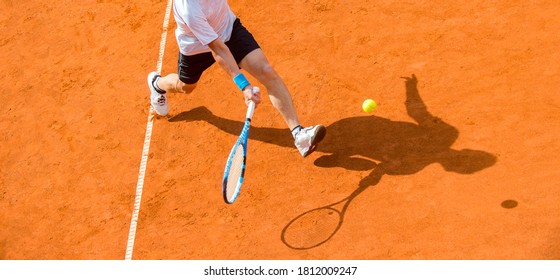 Old Male Tennis Player In Action On The Court On A Sunny Day