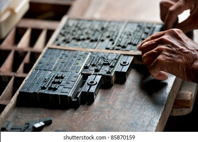 The Old Man Arrange Letterpress For Press On Paper. This Is A Art Of Typography Of Ancient Printing Industry. Typeset Design Is Relate Craft. The Vintage Type Is Still Open Nowadays.