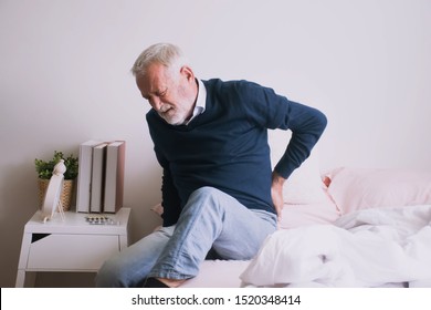 Old Man With Back Ache Clasping  . Man Suffering From Ribbing Pain Or Waist Pain.