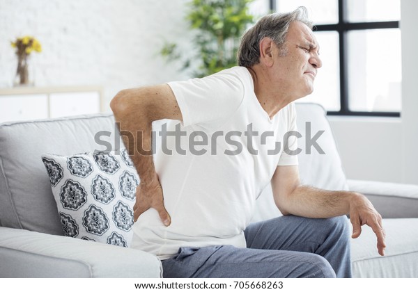 Old man with back\
pain