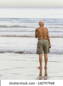 Old Man With Bathing Suit On The Beach