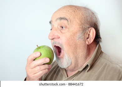 Old Man Biting An Apple