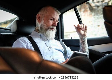 Old Man Businessman With Tablet Inside Car In Daytime