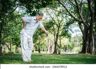 Old Man With Cane Suffering From Back Pain