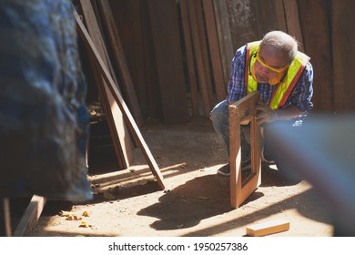 Old Man Carpenter Check Quality Of Shape Wood Frame To Clear Dust On Lighting , Woodworker Industrial 