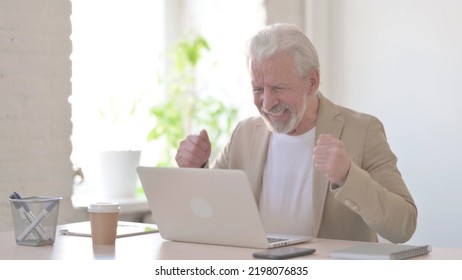 Old Man Celebrating Success While Using Laptop