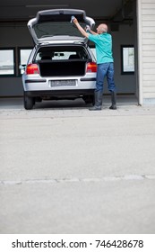 Old Man Cleaning Car