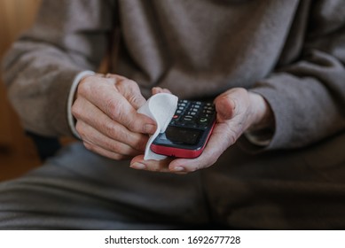 Old Man Cleaning Phone To Prevent Covid-19 Infection