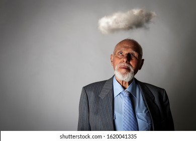 Old man and cloud. Old man is dreaming or thinking about something. Forecasts, prognosis and prediction concept. Looking up.  - Shutterstock ID 1620041335
