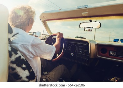 Old Man In A Convertible Driving From Behind