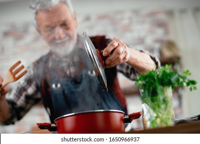 Old Man Cooking. Senior Man In Kitchen. 