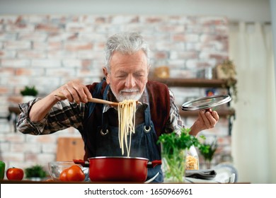 Old Man Cooking. Senior Man In Kitchen. 