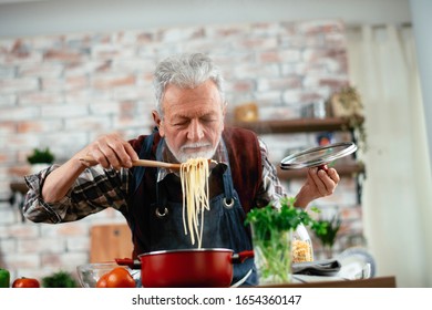 Old Man Cooking. Senior Man In Kitchen. 