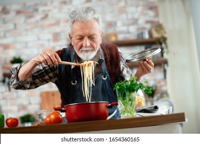 Old Man Cooking. Senior Man In Kitchen. 