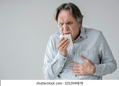 Old Man Coughing To Tissue