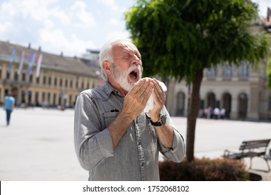 Old Man Coughs And Sneezes Into A Handkerchief On Street, Outdoor, Hot Summer, Allergies And Illness Concept