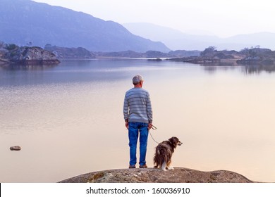 Old Man With The Dog At The Lake In Killarney National Park