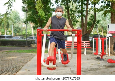 An Old Man Doing Exercise At Outdoor Fitness Equipment In The Park, Concept Health Care In Elderly People, Lifestyle                  
					