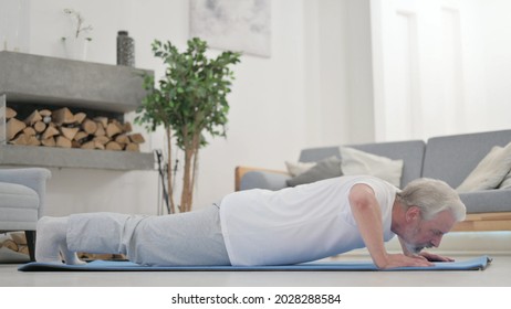 Old Man Doing Pushups On Excercise Mat At Home